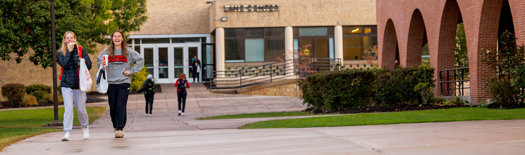 Smiling students walking outside Lane Center