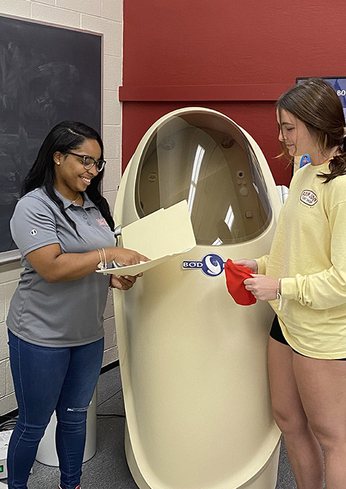 two femal student near a bod-pod