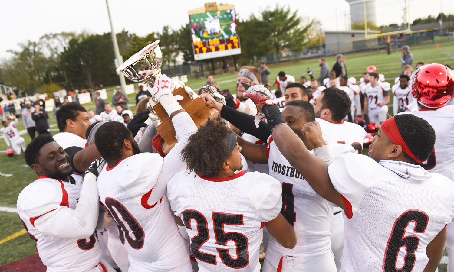 Image of the 2017 Bobcats hoisting the Regents Cup