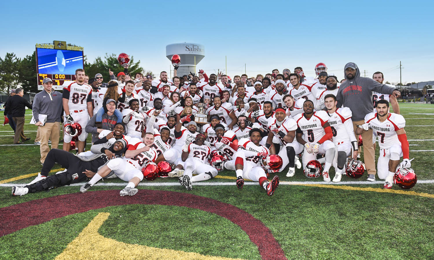 Image of the entire Bobcat team posing with the Regents Cup in Salisbury's Sea Gull Stadium after the second consecutive Bobcat victory