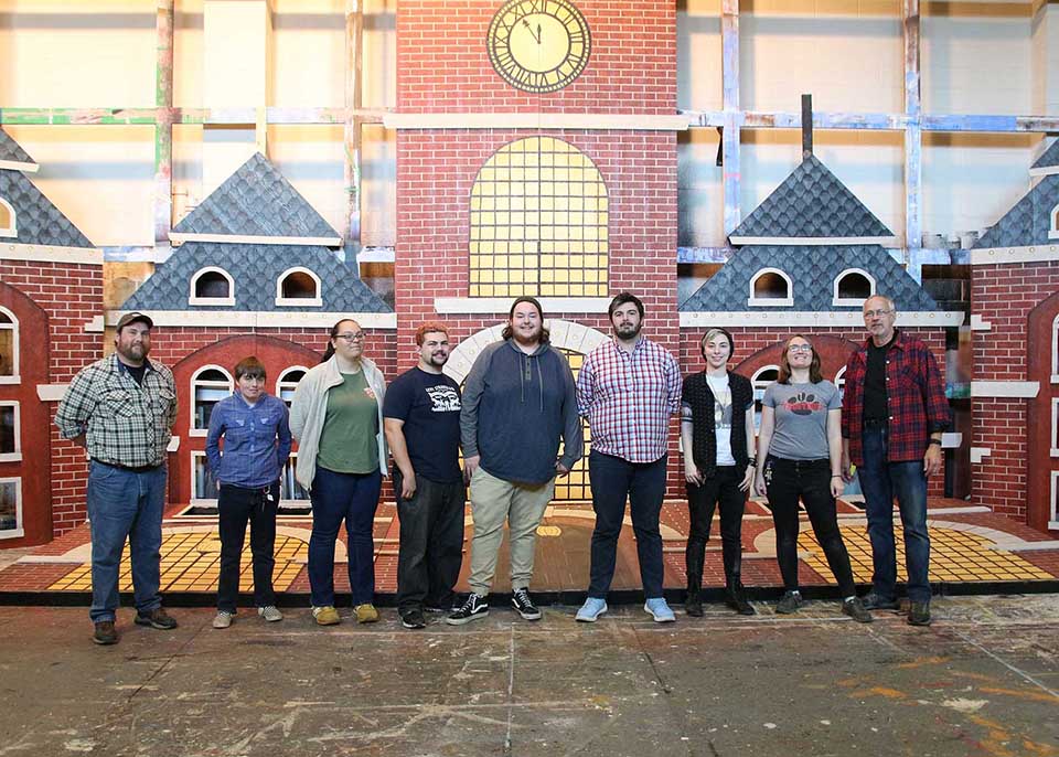 Students pose in front of Polar Express set