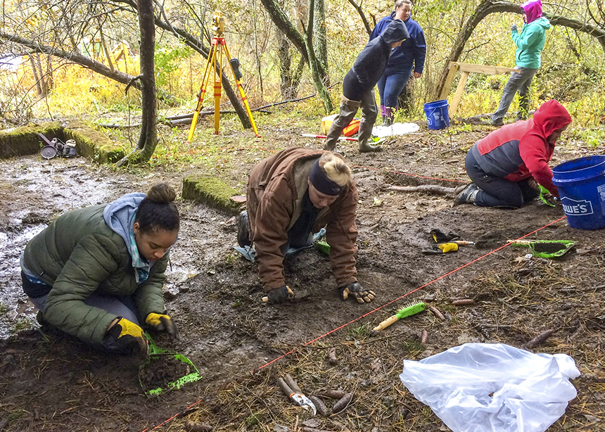students digging at archaeological dig