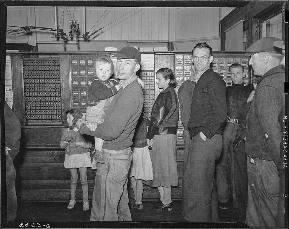 historical photo of people waiting in line