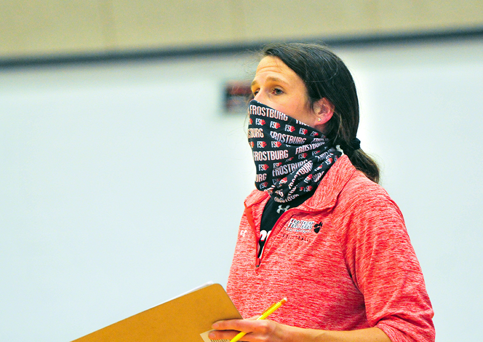 coach wearing face covering