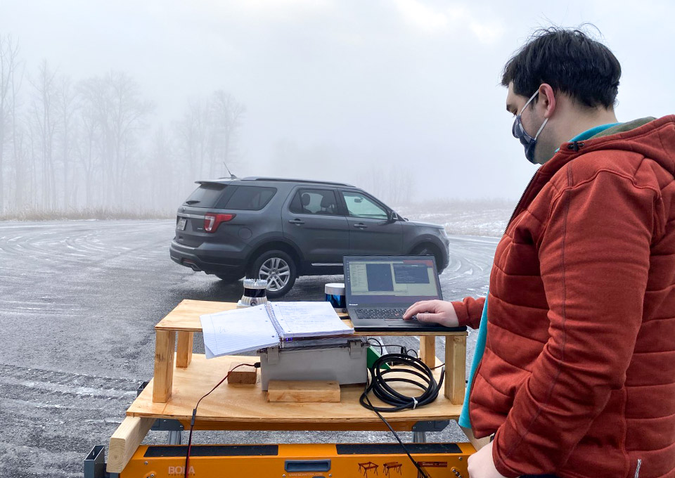 student tests autonomous vehicle in heavy fog
