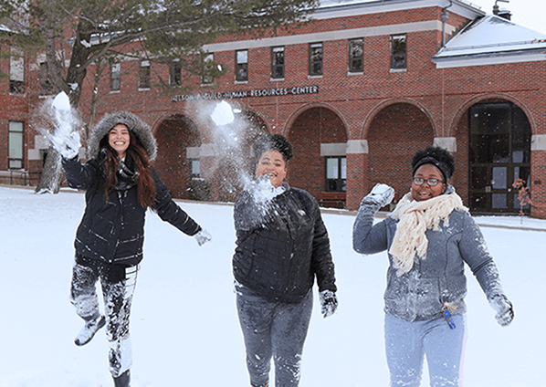 students throwing snowballs