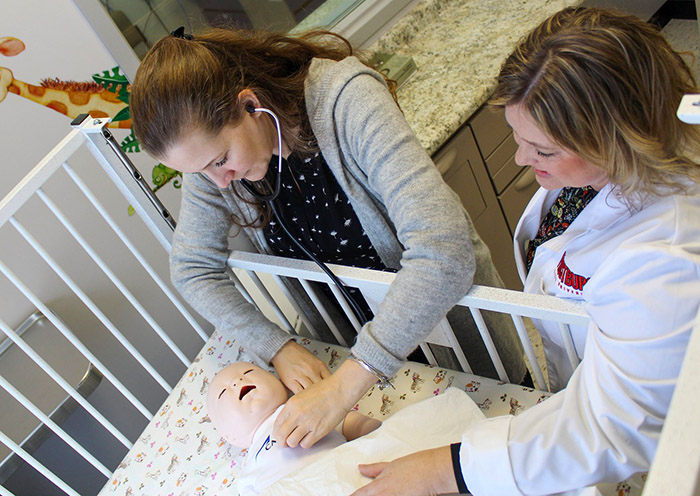 nursing student caring for simulated infant