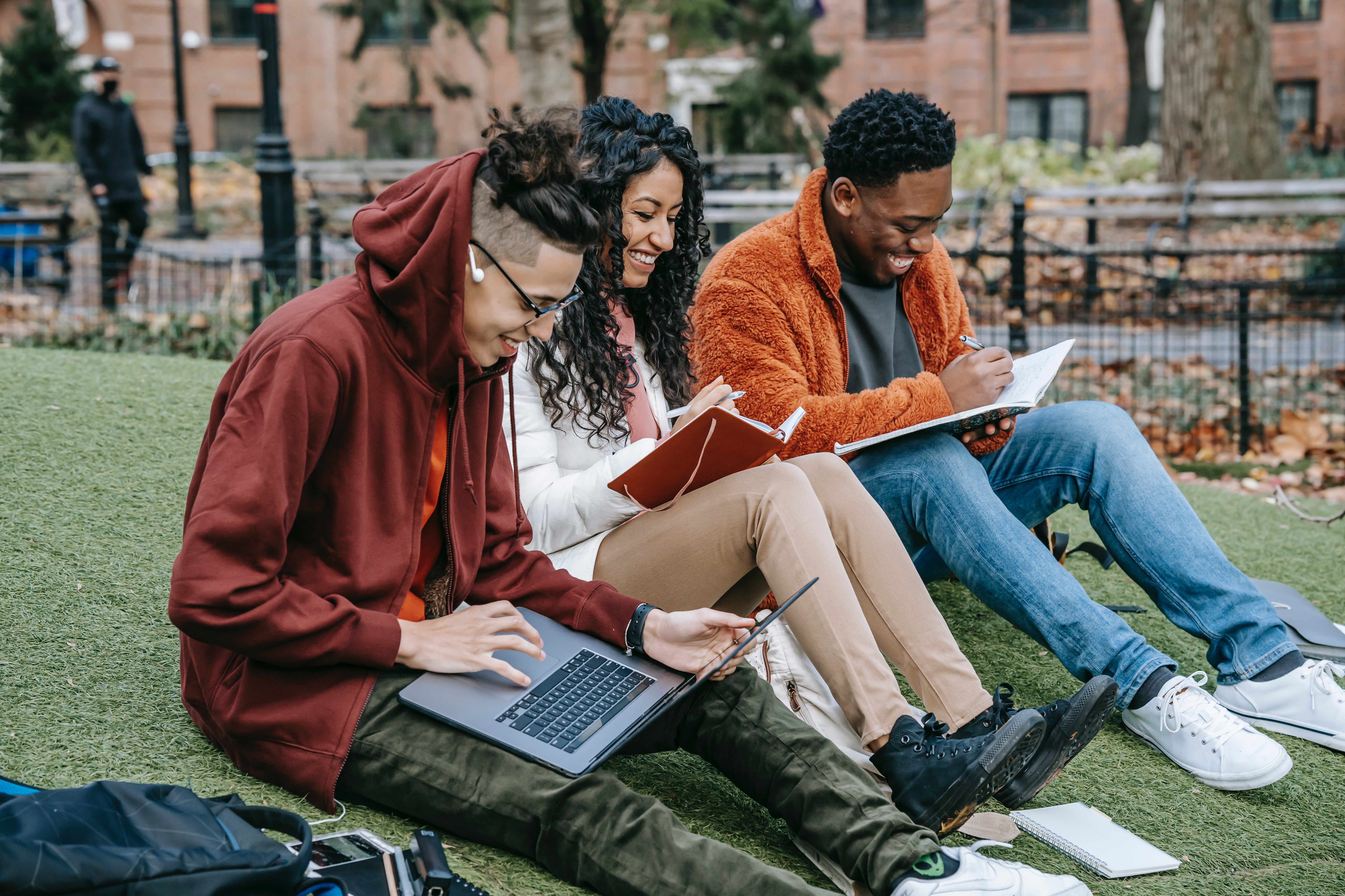 Students outside on FSU campus working on classwork