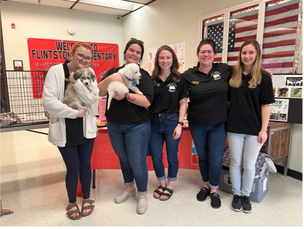 Group photo. CLC staff with dog friends at DOGTOWN celebration.