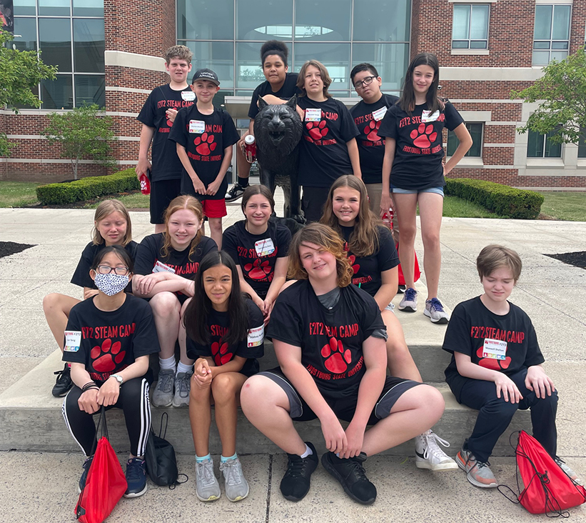 F2T2 STEAM camp campers with our statue