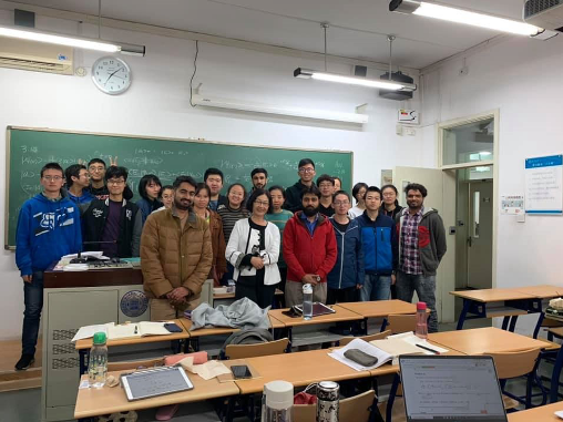 Dr. Deng-Luzader with about 25 students in classroom