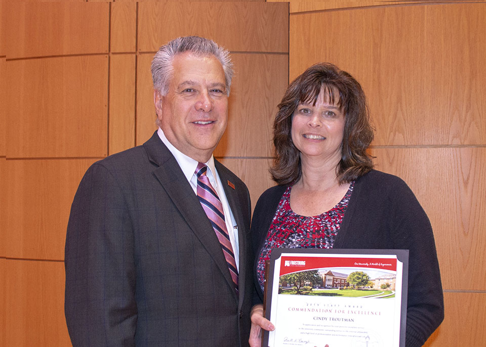 President Nowaczyk and Troutman pose with award