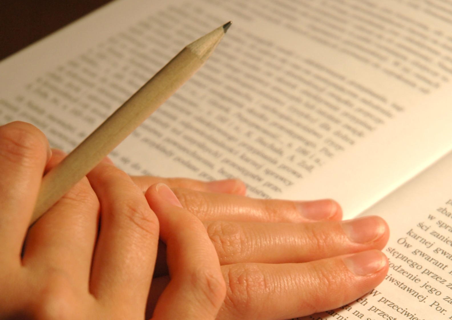 Folded hands on Book for Praxis InformationC