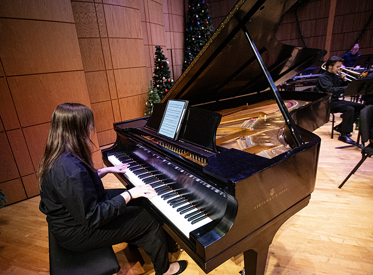 Pianist playing on 9 foot grand piano in the Recital Hall
