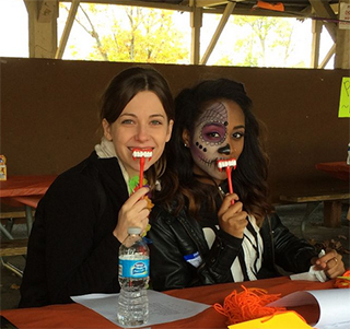 Students working resgistration at the halloween event in Cumberland