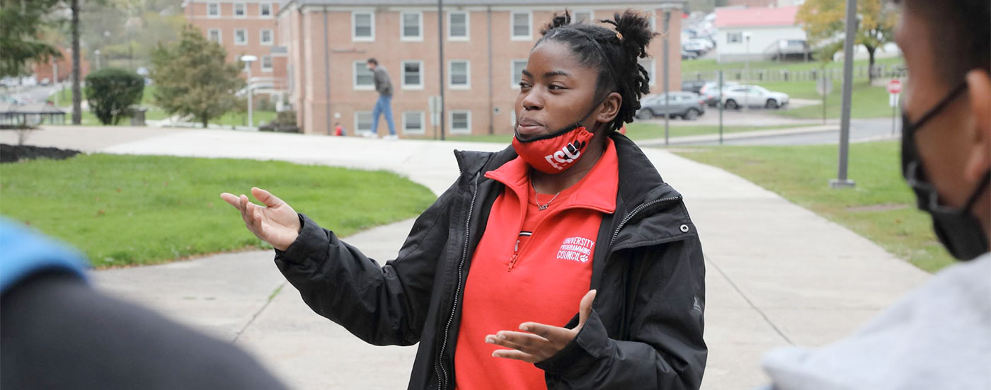 A Bobcat Ambassador gives a tour to prospective students and points out various buildings on campus