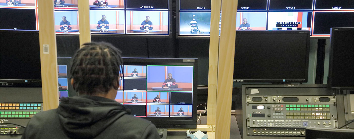 A Frostburg student works in a TV Studio watching various feeds from the cameras