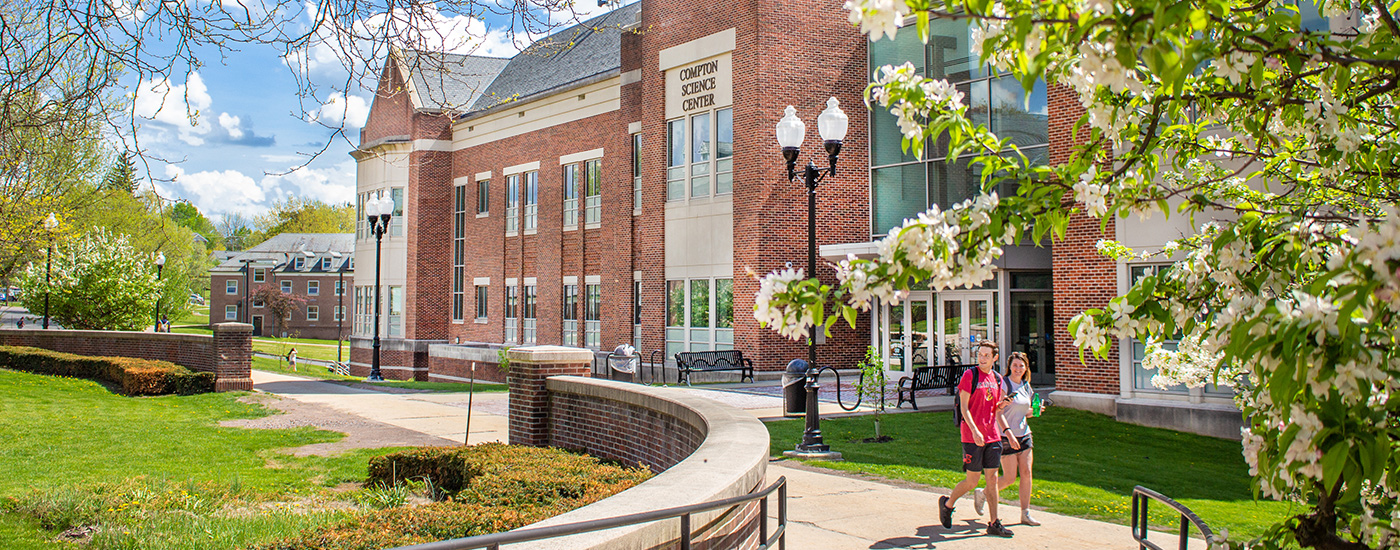 A Frostburg State Student Admissions Ambassador chats with parents and students while walking and giving a tour of campus