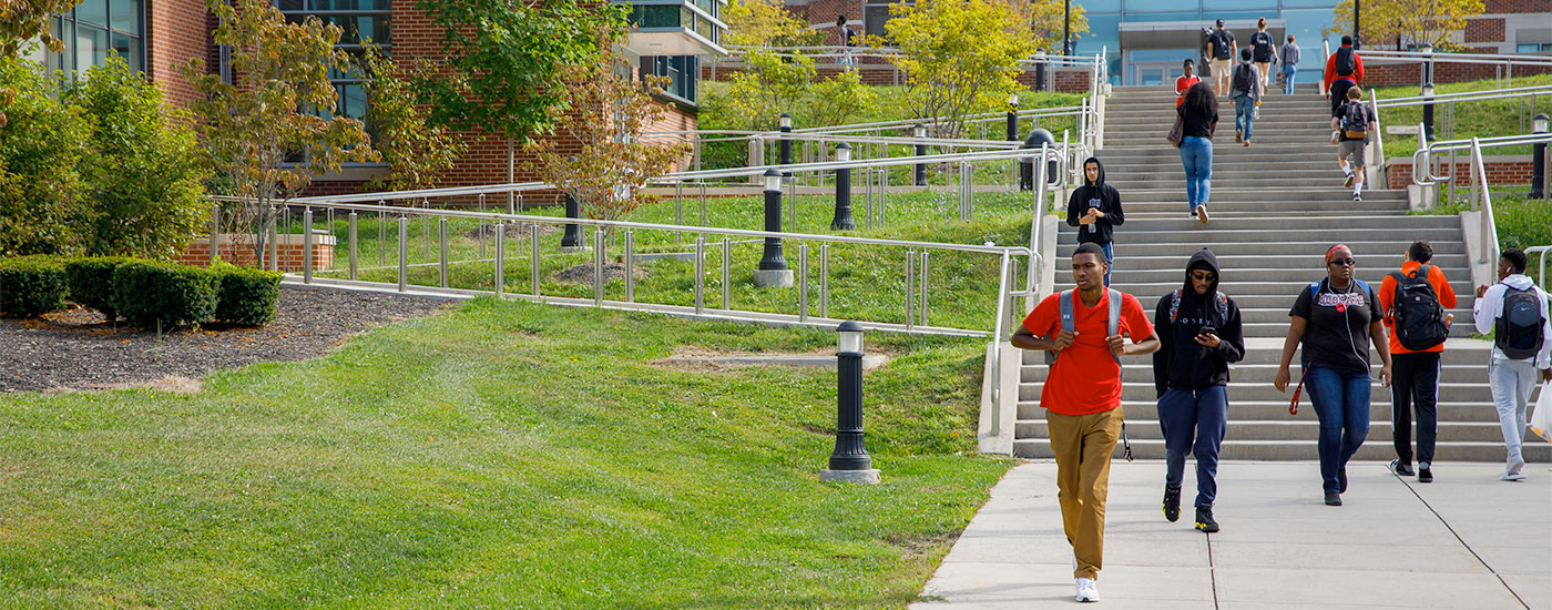 Students walking to and from class via the stairs by the Gira Center