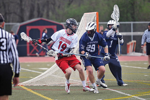 An attackman larosse player cradles the ball away from a long pole defenseman during a game against Mary Washington University