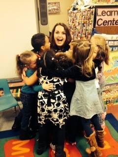 CLC staff member group hug with children