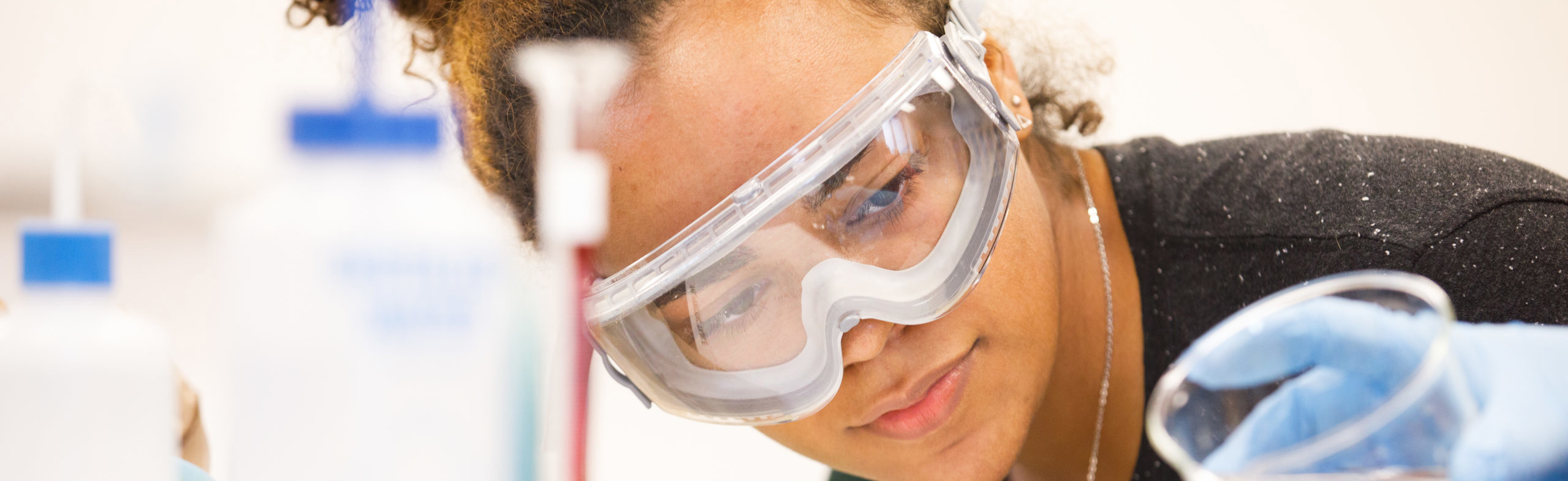 Female science student using beaker