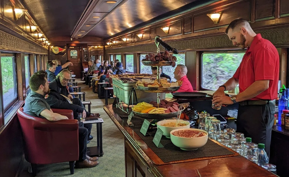 Passengers relax and dine aboard a scenic railway excursion.