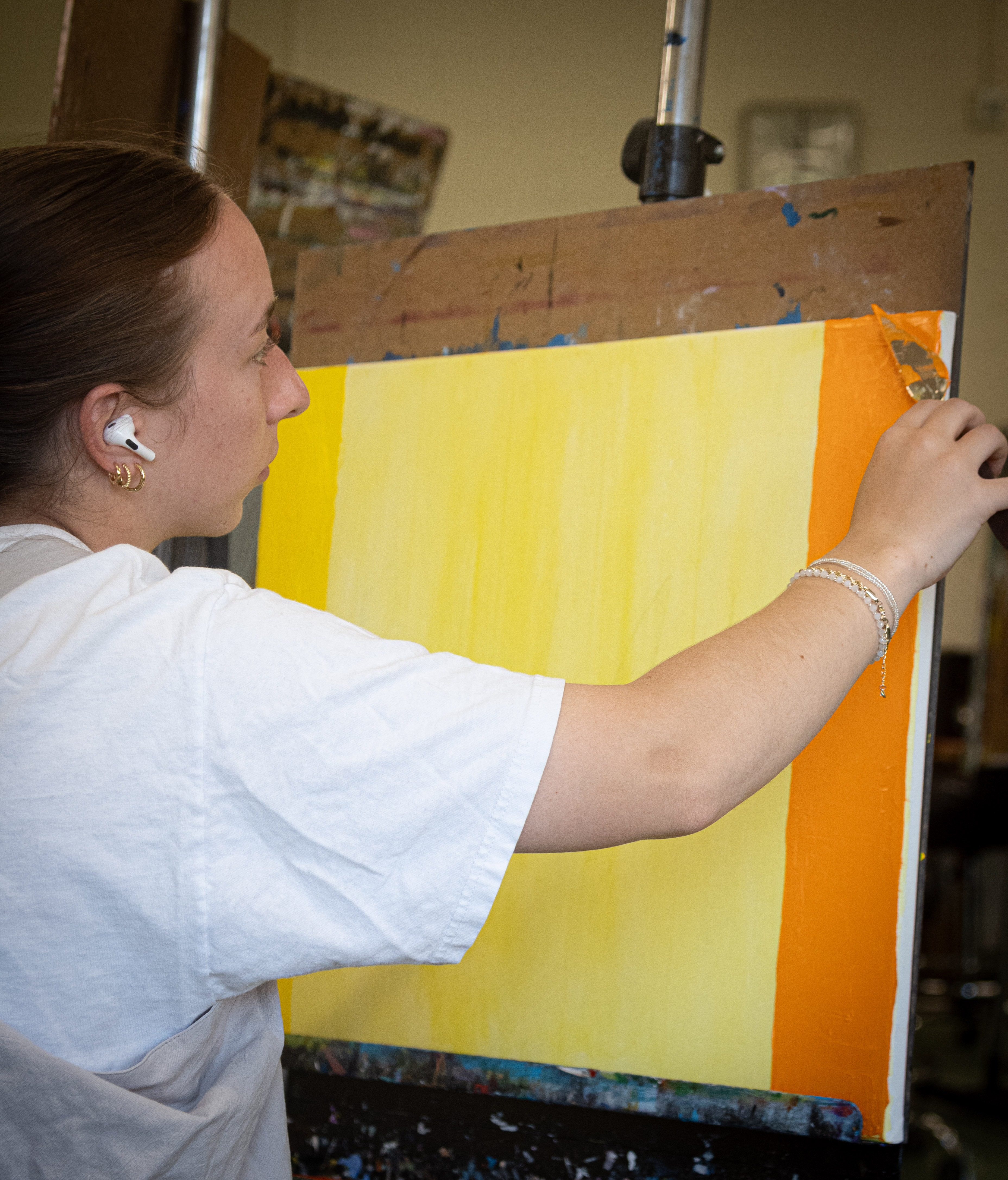 Woman paints with pallete knife on canvas