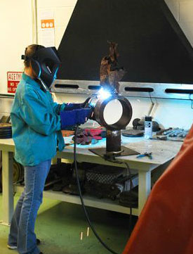 Student, above, working on welding skills.