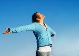 woman raising hands to sky