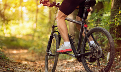 Close up of back wheel as mountian bike passess