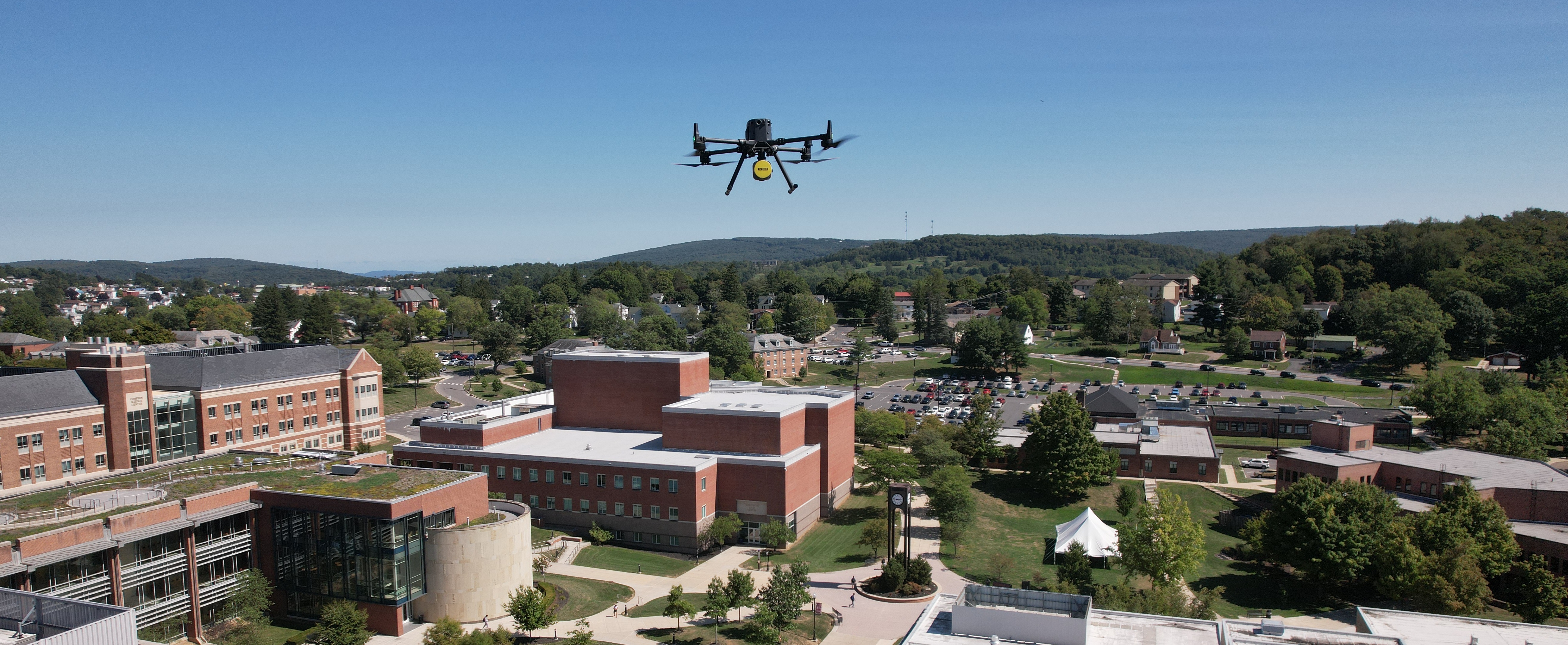 Hovering drone in blue sky