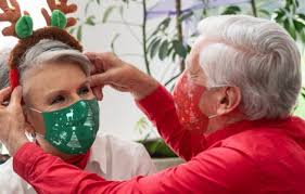 older man adjusting wife's face mask
