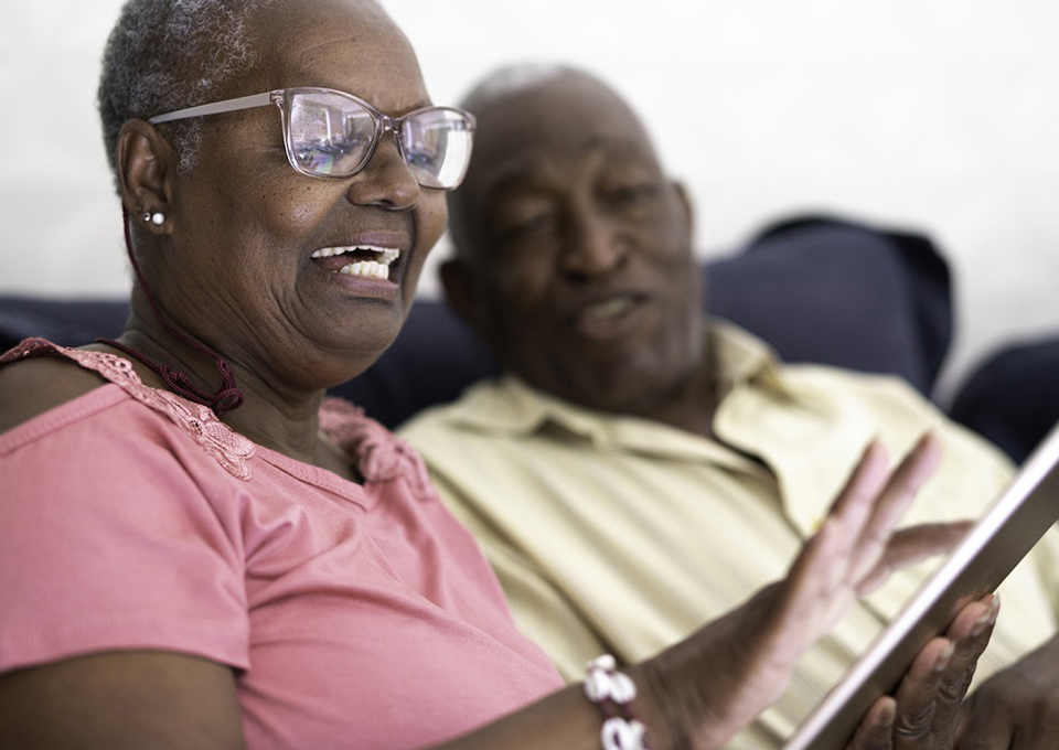 African American senior couple viewing a tablet
