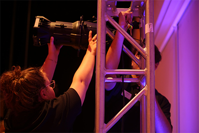 One student internship includes setting up lighting
