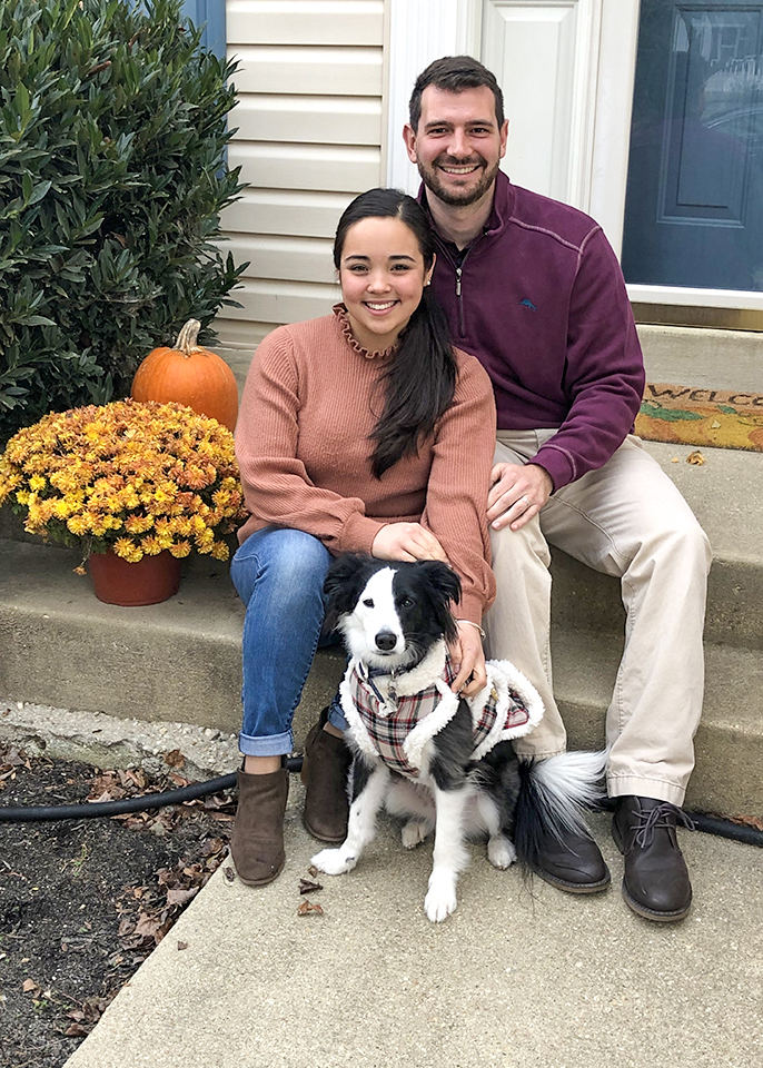 Alanna Hirshman ’16 and Zach Keeler ’16 sit on front proch steps with dog Ellie-Roo