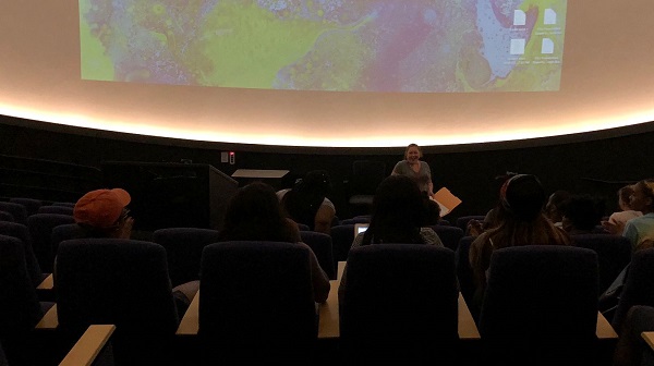 Professor Annie Danzi speaking in front of her class before using the MLC theater to present student final projects