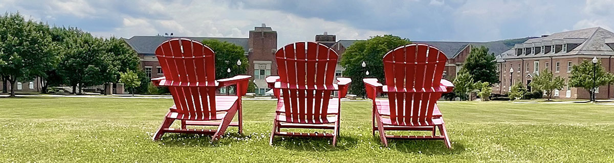 red adirondack chairs overlook the upper quad