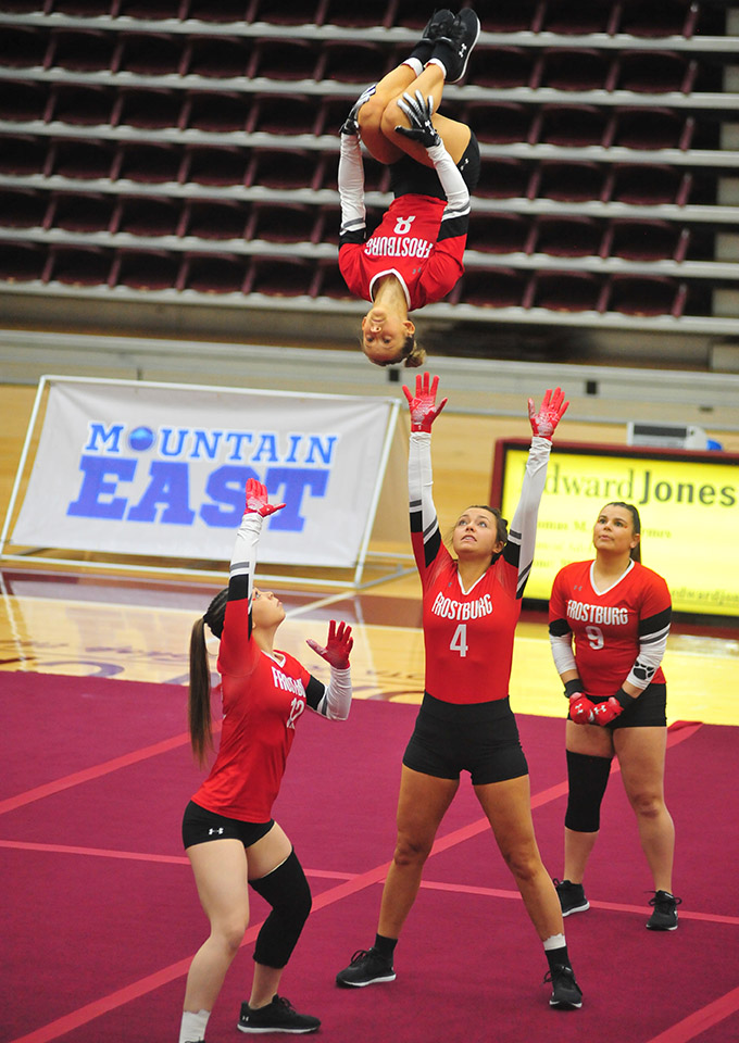 acro-tumbling team perform stunt of tossing teammates into the air