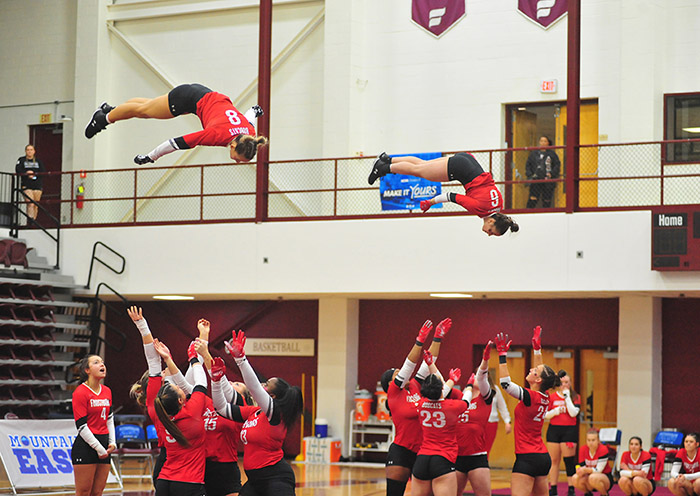 team members twirl in the air