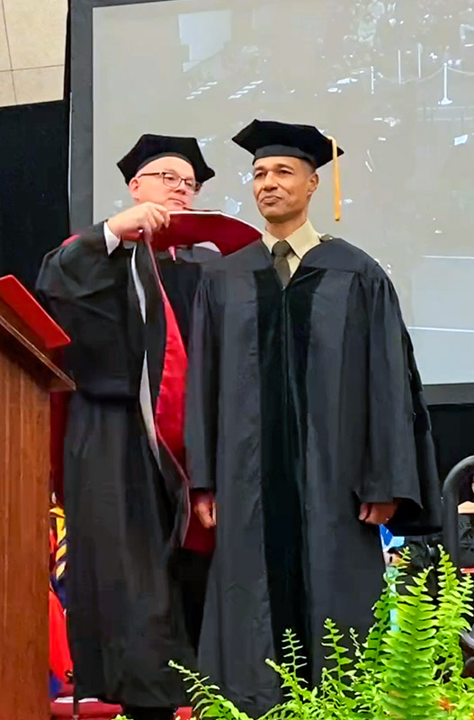 Maj. Gen. Robert L. Edmonson II getting hooded at ceremony