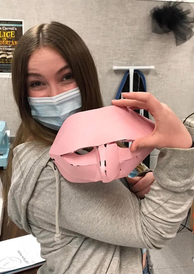 female festival goer shows off homemade mask