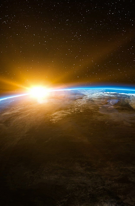 space image of sun on earth's horizon