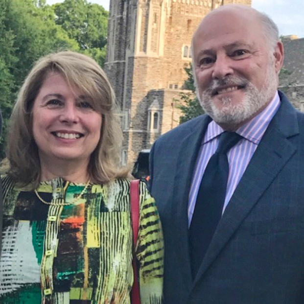 John and Karen Bambacus in front of a stone castle-like building