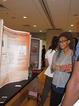 Student presents research at a poster session for the annual Undergraduate Research Symposium