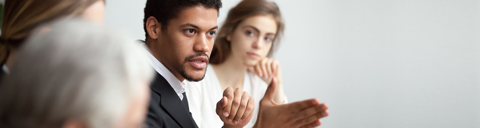 man using hand gesture while speaking to a group