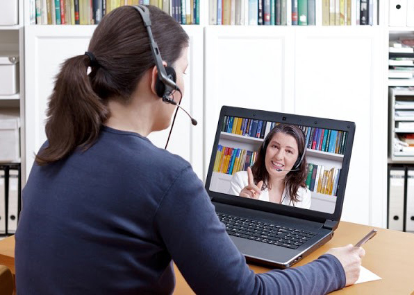 female student watches her tutor online