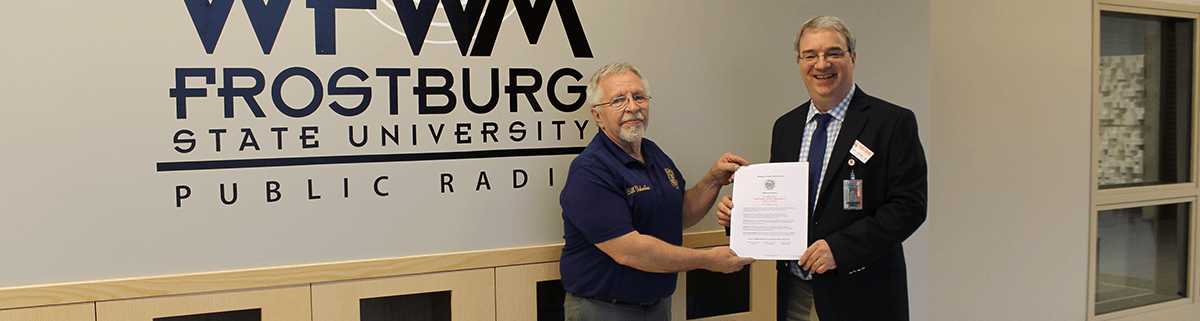 Commissioner Valentine presents proclamation to station director Chuck Dicken
